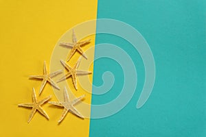 Summer background of yellow and blue paper with starfish, symbol