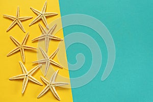 Summer background of yellow and blue paper with starfish, symbol