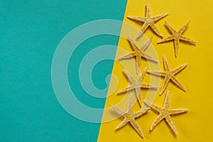 Summer background of yellow and blue paper with starfish, symbol