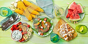 Summer bbq party concept - grilled chicken, vegetables, corn, salad, top view