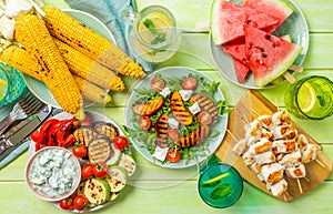 Summer bbq party concept - grilled chicken, vegetables, corn, salad, top view