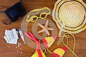 Summer beach accessories and medicine on the table.