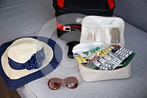 Summer beach accessories for your sea holiday and pills. Concept of medication required in journey