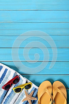 Summer beach background border, sunglasses, flip flops, starfish, vertical