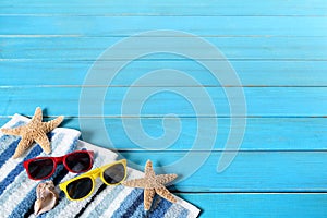 Summer beach background border, sunglasses, starfish, blue wood copy space