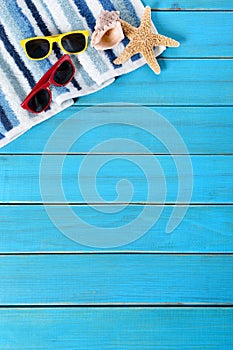 Summer beach background border, sunglasses, towel, starfish, vertical