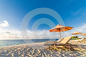 Summer beach background. Vacation and holiday concept, lounge chairs near the sea, luxury scenery