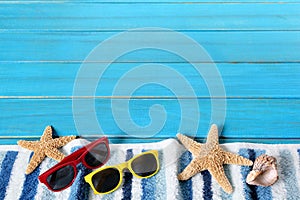 Summer beach border, starfish, sunglasses, blue wood, copy space