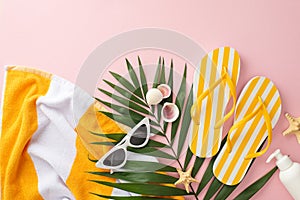 Summer beach holiday concept. Top view flat lay of yellow striped flip-flops, towel, green palm leaves, vintage sunglasses,