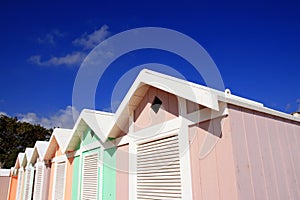 Summer beach huts on blue sky