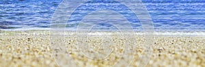 Summer beach low angle view background.Close up wave of blue sea on sand beach seashore
