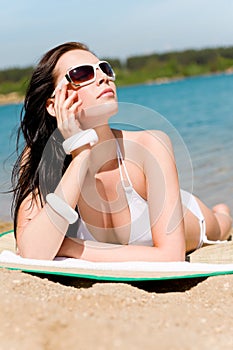 Summer beach stunning woman sunbathing in bikini