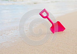 Summer beach toy in the sand by the water.