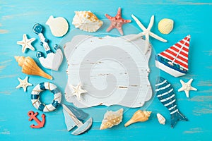 Summer beach vacation background with wooden board sign, sailing boat and nautical decorations. Top view from above