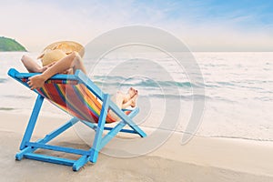 Summer beach vacation concept, Asia woman with hat relaxing and arm up on chair beach at Koh Mak, Trad, Thailand