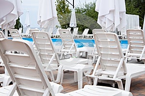 summer beach vacation. summertime lifestyle. outdoor resort at poolside. pool sunbed and sun lounger. Poolside lounging