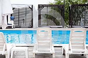 summer beach vacation. summertime lifestyle. outdoor resort at poolside. pool sunbed and sun lounger. Relaxing by the poolside