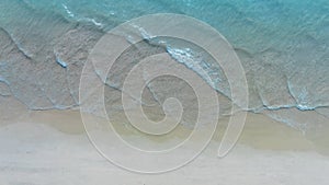 Summer beach in wave of turquoise sea water shot, Top view of beautiful white sand background