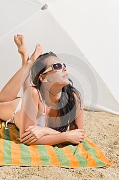 Summer beach young woman sunbathing in bikini