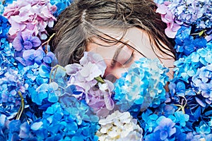 Summer beauty. Makeup cosmetics and skincare. Spring woman with hydrangea flowers. Fashion portrait of woman. Healthy