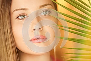 Summer beauty, makeup and skincare, face portrait of beautiful woman with tropical palm tree leaf, natural makeup for