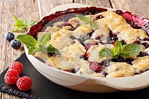 Summer berry cobbler of raspberries and blueberries close up in