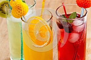 Summer beverages, cocktail with ice, juice and fruit.