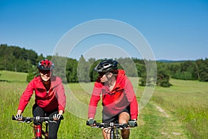 Summer bike - Young sportive couple in meadow