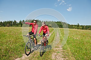 Summer bike - Young sportive couple in meadow