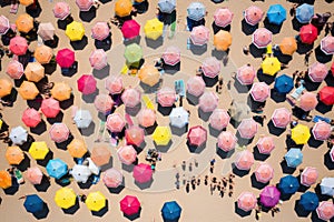 Summer Bliss: A Colorful Aerial View of Crowded Beachgoers Relaxing under Colorful Umbrellas on a Beautiful Sandy Shore