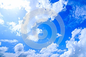 Summer blue sky background, white clouds and highlight of sun in