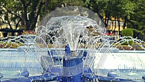 Summer blue urban cascading fountain in the central park.