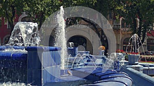 Summer blue urban cascading fountain slow motion