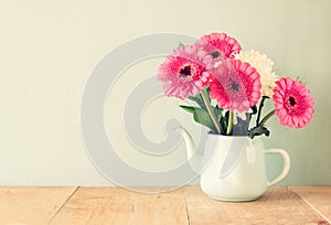 Summer bouquet of flowers on the wooden table with mint background. vintage filtered image