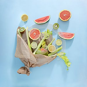 Summer bouquet of fresh, tropical fruits. Organic creative concept on pastel blue background. Healthy food lifestyle. Flat lay
