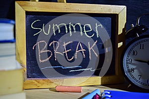 Summer break on phrase colorful handwritten on blackboard