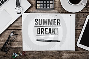 Summer Break statement on notepad on office desk from above