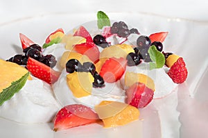 Summer breakfast dessert with fresh fruits on ice cream or yogurt healthy diet food vitamin-rich. White Whipped Meringue