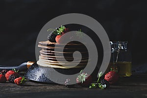 Summer breakfast with pancakes, strawberries, blackberries and h