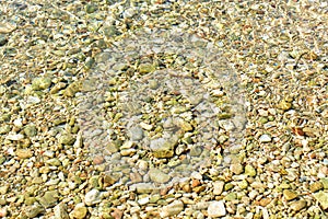 Beautiful delicated texture of little stones under the water, in Ibiza.