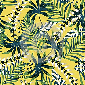 Summer bright original seamless pattern with tropical leaves and plants on a yellow background. Vector design. Jung print. Floral