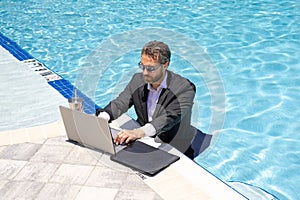 Summer business. Business success. Funny office worker online work, e-working. Summer businessman in suit with laptop in