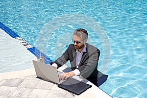 Summer business. Business success. Funny office worker online work, e-working. Summer businessman in suit with laptop in