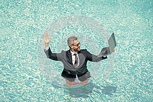 Summer business dreams. successful man. Businessman in suit with laptop in swimming pool. business man on summer