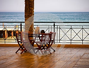 Summer cafe on the terrace overlooking the sea. Pier, shore, surf, Photography.