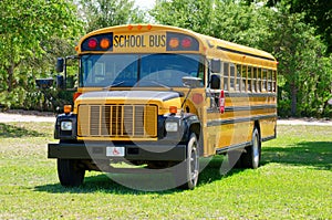 Summer camp school bus in grass field