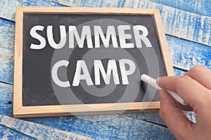 Summer camp, text words typography written on chalkboard against wooden background, life and business motivational inspirational