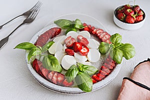 Summer Caprese salad with strawberries. Strawberry salad with basil and mozzarella