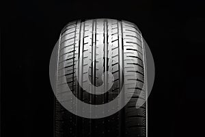 summer car tire tread, front view, black background