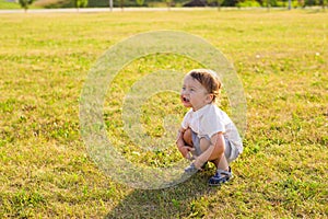 Summer, childhood and baby concept - little boy having fun in summer nature.